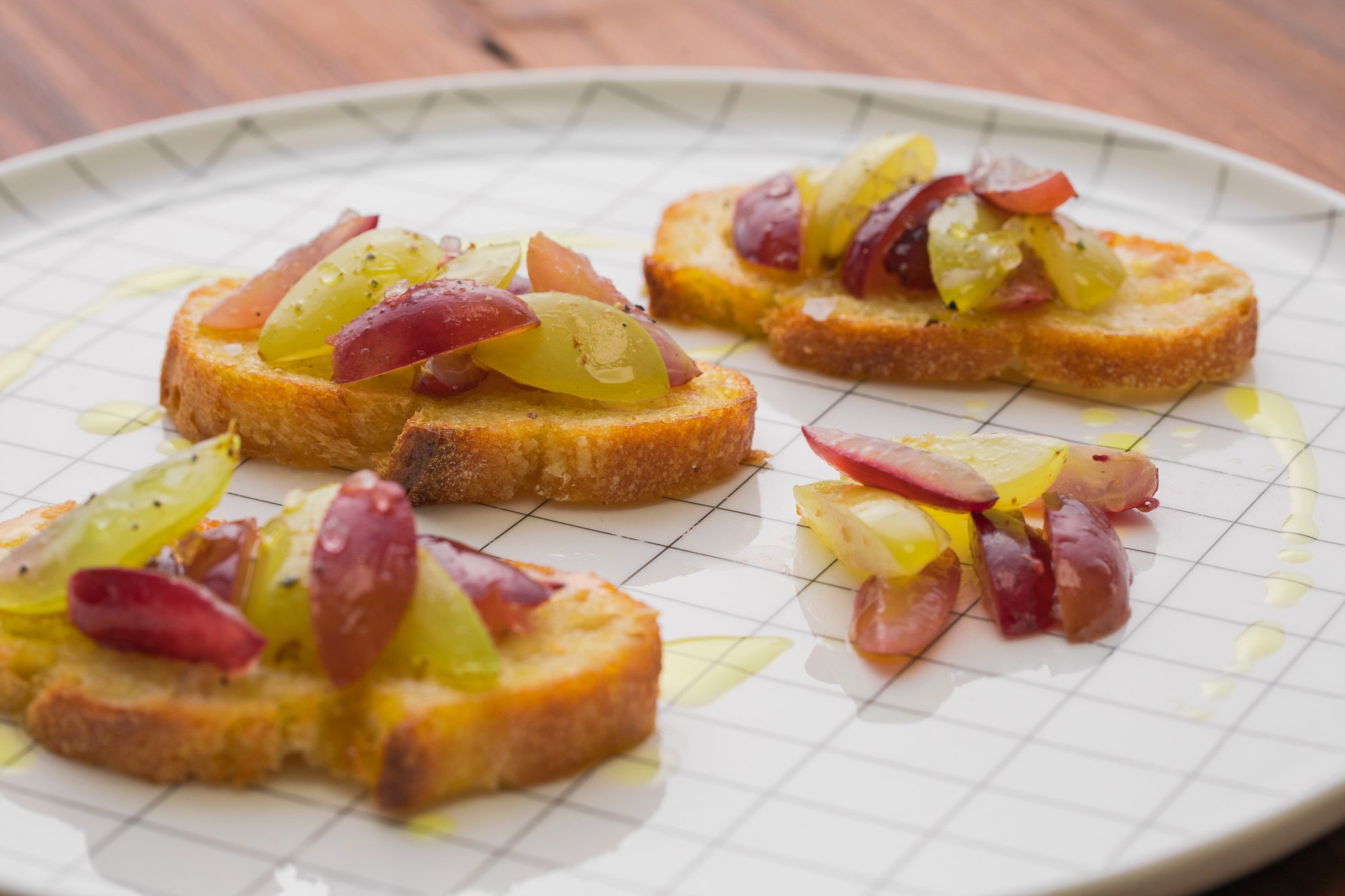 Roasted grape crostini made with Bertolli Oil.